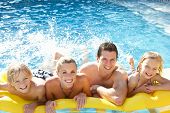 picture of holidays  - Young family having fun together in pool - JPG 