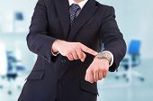image of watch  - Business man pointing at his wrist watch - JPG 