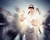 stock photo of business concept  - Image of businesswoman in blindfold walking among group of people - JPG 