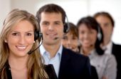 stock photo of support  - business customer support team in an office with headsets - JPG 