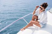 foto of holidays  - Woman sailing in a yacht on her summer holidays - JPG 