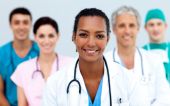 foto of ethnic  - Attractive female Doctor standing before her team - JPG 