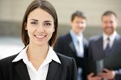 image of business people  - Beautiful woman on the background of business people - JPG 
