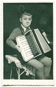 image of  photo  - Vintage photo of boy playing an accordion  - JPG 