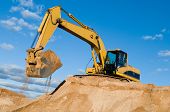 image of construction  - excavator loader machine during earthmoving works outdoors at construction site - JPG 