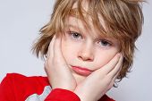 stock photo of puzzel  - A young boy looks confused and unsure - JPG 