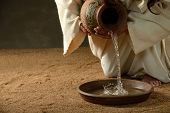 stock photo of religion  - Jesus pouring water from a jug  - JPG 