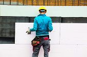 picture of construction  - construction workers at a construction site when the building insulation - JPG 