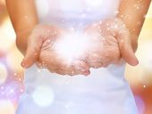 foto of health  - bright closeup picture of magic twinkles on female hands - JPG 