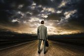 stock photo of future  - Business man standing in the middle of the road - JPG 