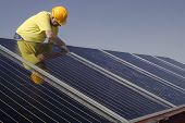 picture of construction worker  - Worker and Solar panels on a house roof - JPG 