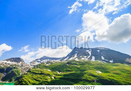 Beautiful Picture Of The Alpine Landscape With Snow And Green Meadows