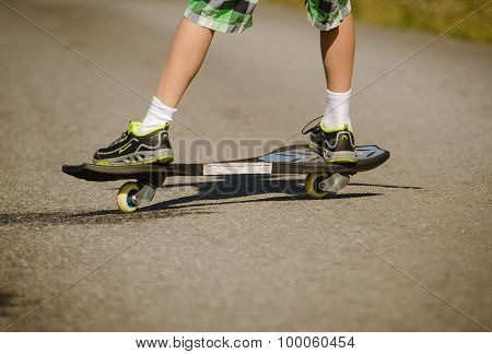 Legs in sneakers on a skateboard