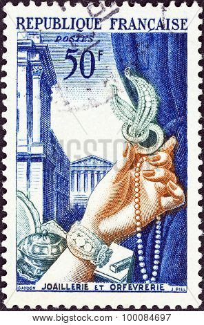FRANCE - CIRCA 1953: A stamp printed in France shows Gold plate and jewellery