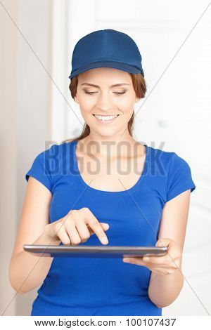 Nice deliverywoman standing near door