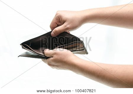 Empty wallet in male hands as symbol poverty and unemployment. Finance and poor economy. Isolated on white. Studio shot.