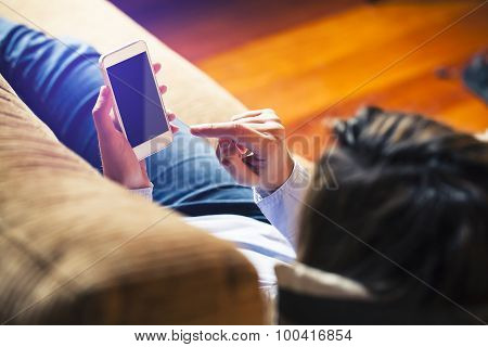 Woman Touching Mobile Screen With Finger, Lying At Home. Black Screen.