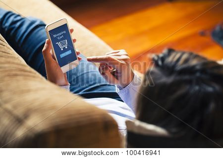Woman Shopping By Mobile Phone Laying At Home. Blue Screen.