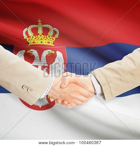 Businessmen Handshake With Flag On Background - Serbia