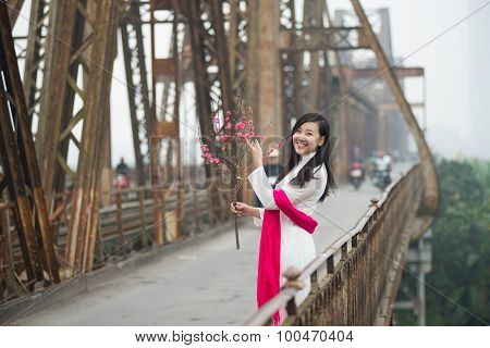 Vietnamese girl on Long Bien bridge in Hanoi, Vietnam