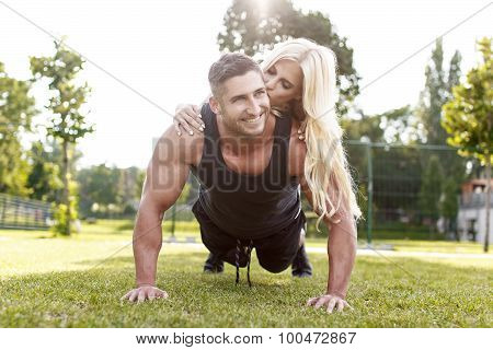 Fit Man Doing Push-ups With Woman On Back