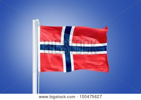 Flag of Norway flying against a blue sky.