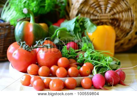 Tomatoes, radishes, peppers, parsley and wickerwork handbasket