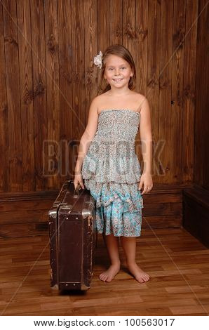 Smiling girl keep ancient brown scratched suitcase
