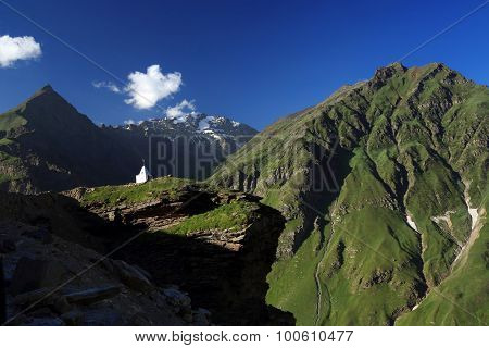 White Tibetan Stupa On Top Of Mountain With High Mountain Background, Northern India