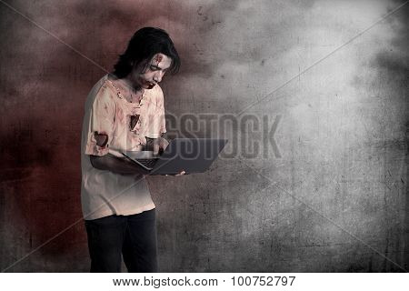 Scary Male Zombie Typing With Laptop