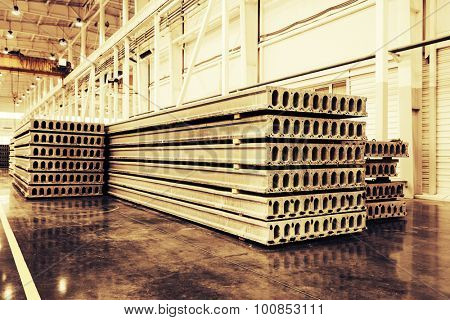 Stack of precast reinforced concrete slabs in a house-building factory workshop