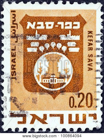 ISRAEL - CIRCA 1969: A stamp printed in Israel shows coat of Arms of Kefar Sava