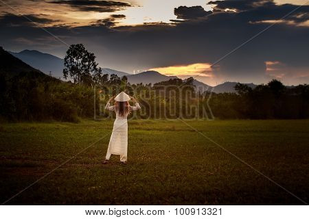View Of Sky Clouds At Sunset With Girl Backside View On Field