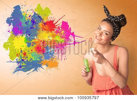 Cute girl blowing bubble spalsh graffiti into wall