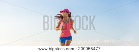 People lifestyle banner healthy woman running. Blue sky copyspace.