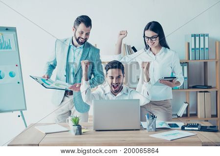 Yes! We Did It! Success And Team Work Concept. Team Of Three Business Partners With Raised Up Hands