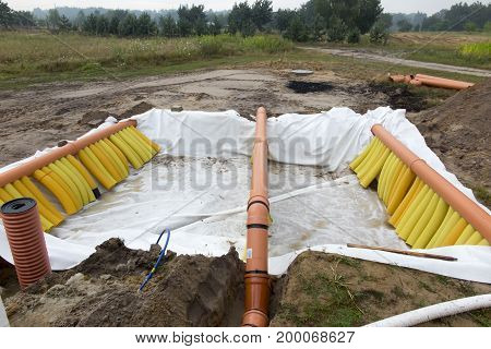 Building a ground heat exchanger to heat up the air in winter and cool down in summer