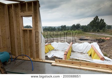 Building a ground heat exchanger to heat up the air in winter and cool down in summer