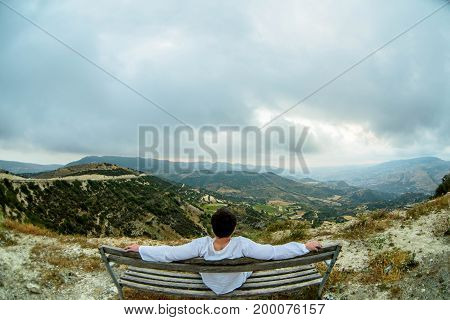 Man sitting on bench in cyprus mountains