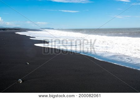 Black sand beach, Reynisfjara shore near the village Vik, atlantic ocean, Iceland.