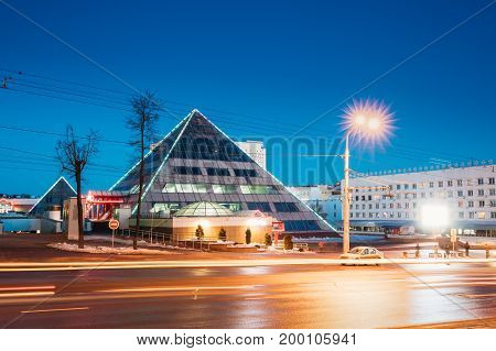 Vitebsk, Belarus. Shops In Pyramid Shape In Lenin Street At Winter Season. View From Gogol Street In Evening Or Night Illumination In Vitebsk, Belarus