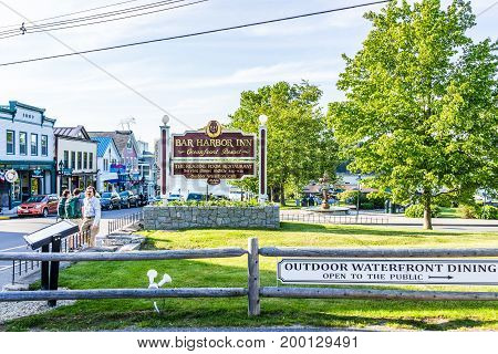 Bar Harbor USA - June 8 2017: Oceanfront resort inn sign with waterfront dining and harbor in downtown village in summer