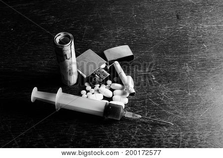 The Drug In Syringe  Put On The Table  With The Money , Cigarette,lighter And Yellow - White Medicin