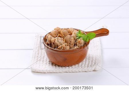 saucepan of soy meat cubes on white table mat