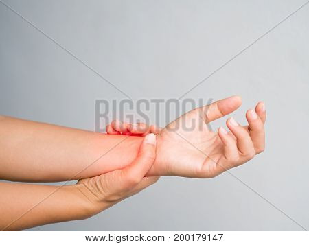 Health care concept. Close up woman holding her wrist symptomatic Office Syndrome. Pain in the joints of the hands. Carpal tunnel syndrome.