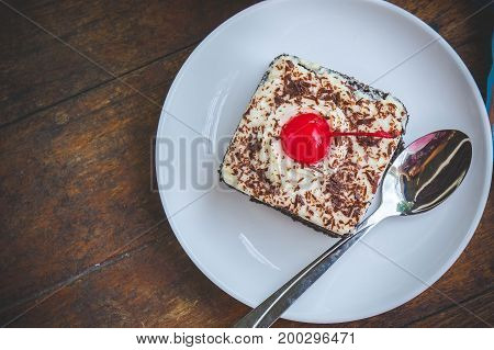 tasty chocolate cherry cake dessert on wood table and copy space
