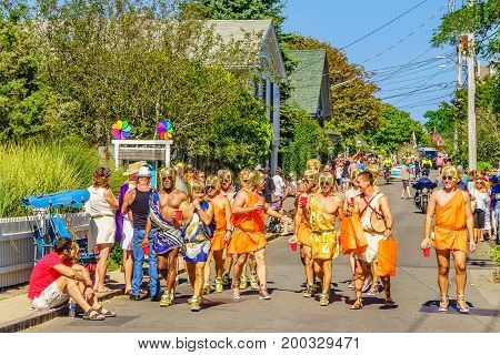 Provincetown Massachusetts US August 17 2017 People walking in the 39th Annual Provincetown Carnival Gods and Goddess Parade on Commercial Street