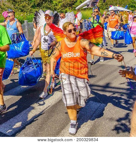 Provincetown Massachusetts US August 17 2017 People walking in the 39th Annual Provincetown Carnival Gods and Goddess Parade on Commercial Street