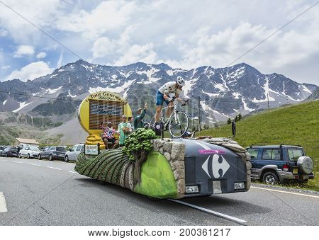 Col du Lautaret France - July 19 2014: The vehicle of Carrefour during the passing of the advertising caravan on mountain pass Lautaret during the stage 14 of Le Tour de France 2014. Before the appearance of the cyclists there is a caravan of advertising