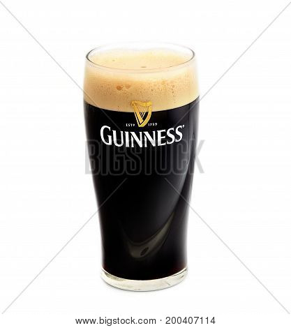 POLTAVA, UKRAINE - APRIL 4, 2017: Pint of Guinness, the popular Irish beer on a white background